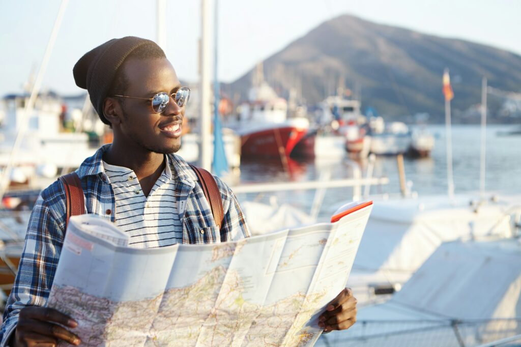 People, lifestyle, travel and tourism concept. Handsome fashionable young African American male tour