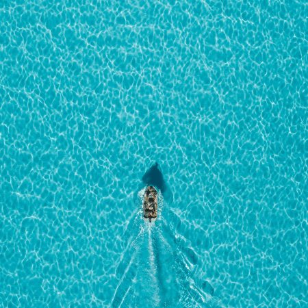 A boat sailing on clear turquoise water