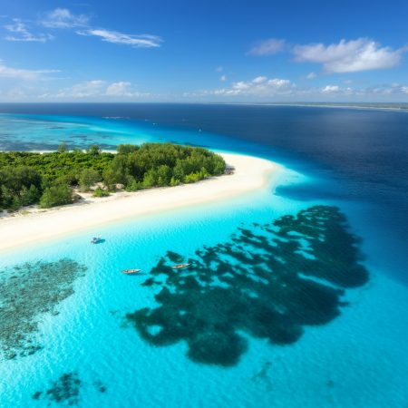 Aerial view of blue sea and Mnemba island, Zanzibar. Top view