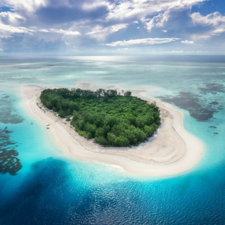 Aerial view of blue sea and Mnemba island, Zanzibar. Top view