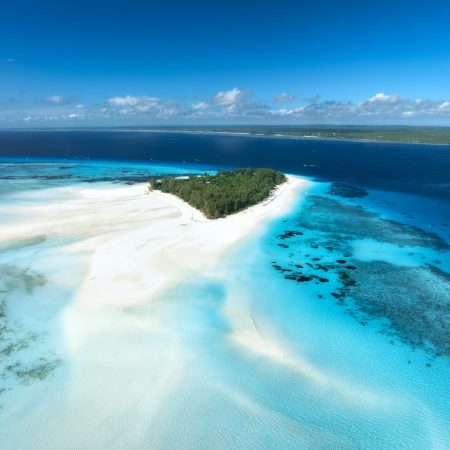 Aerial view of blue sea and Mnemba island, Zanzibar. Top view