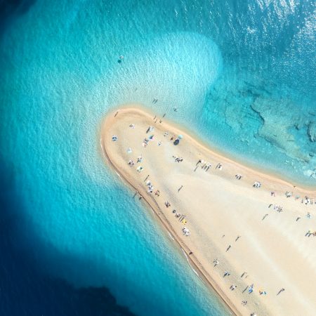 Aerial view of blue sea, sandbank, white sandy beach in summer