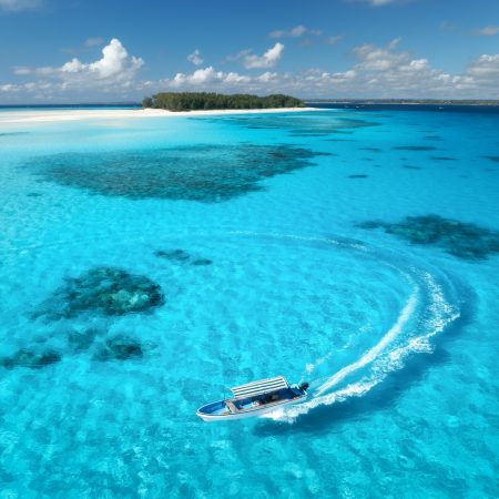 Aerial view of colorful boats, sandbank, blue sea on sunny day