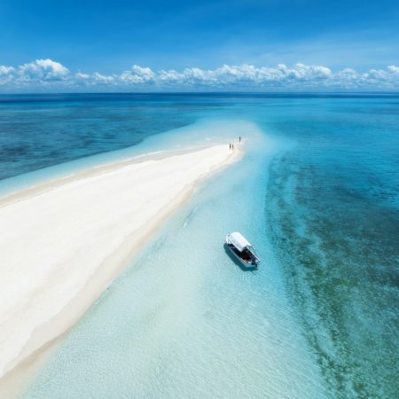 Aerial view of island, sandbank in ocean, sandy beach, boat