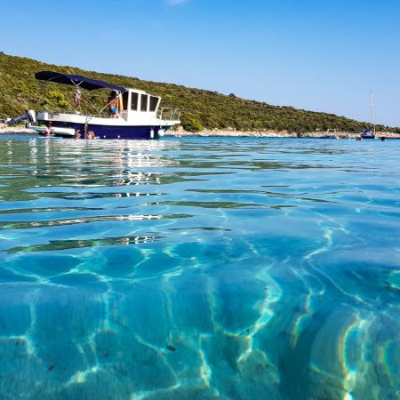 Boats moored in bay of sea with beautiful turquoise water.