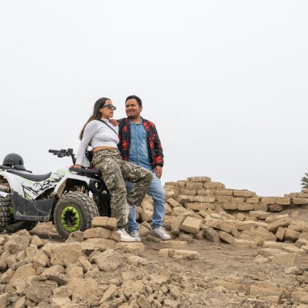 Couple sitting on a quad bike on a beach