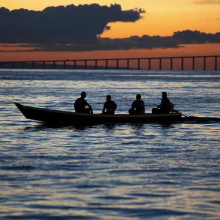 Sunset and silhouettes on boat cruising the Amazon River, Brazil