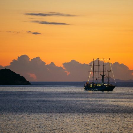 View of cruise sailing ship at sunset