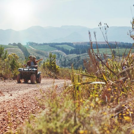 Young couple having fun on quad bike